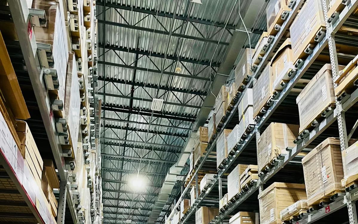 Long warehouse aisles of shelving stacked with boxed stock