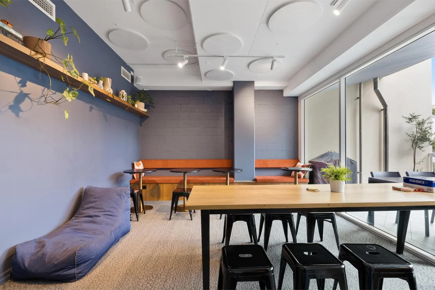Breakout space with communal table and bean bags at LINK Coworking