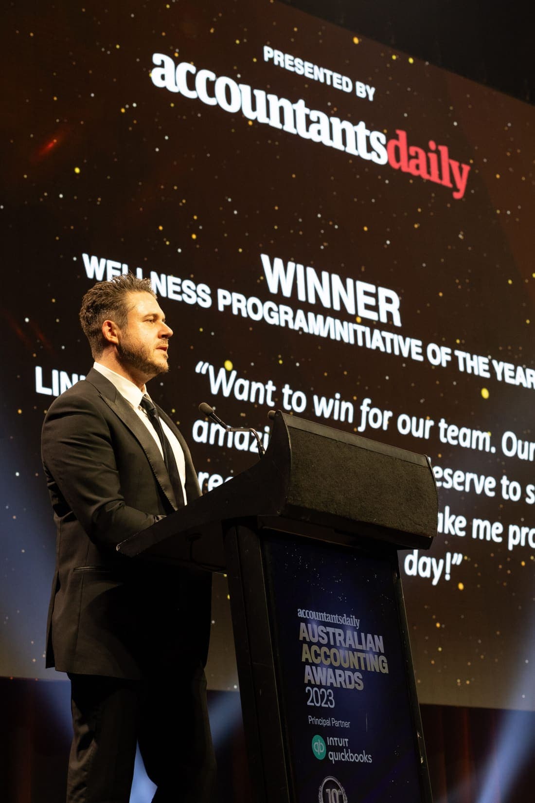 James Webb on stage accepting the Wellness Program of the Year award in 2023